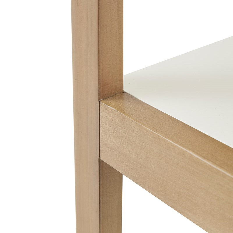 Close-up of a wooden shelf with a white surface on a white background